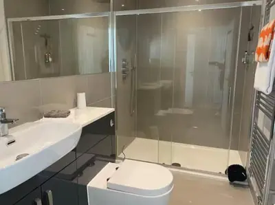a bathroom with a shower and a toilet and a sink at The Lodge at Muir Estate in Thornhill