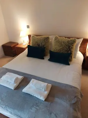 a large white bed with two pillows on it at Quartermile Luxury Landing Apartment in Edinburgh