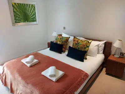 a bedroom with a bed with two towels on it at Quartermile Luxury Landing Apartment in Edinburgh