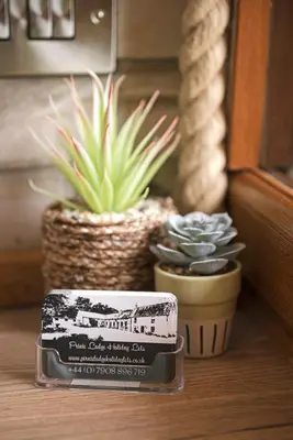 a container of food sitting next to two potted plants at Pirnie Lodge Holiday Lets in Slamannan