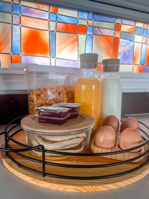 a tray of food with bottles of milk and eggs at Pirnie Lodge Holiday Lets in Slamannan