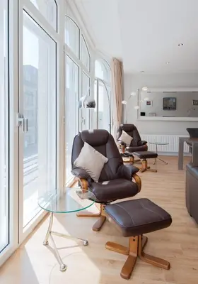 a living room with two chairs and a glass table at Shandwick Apartment - Edinburgh City Centre - Sleeps 2 in Edinburgh