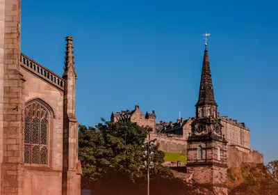 a building with a tower and a church with a steeple at Shandwick Apartment - Edinburgh City Centre - Sleeps 2 in Edinburgh