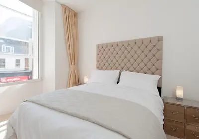 a white bedroom with a large bed and a window at Shandwick Apartment - Edinburgh City Centre - Sleeps 2 in Edinburgh