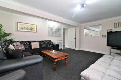 a living room with a couch and a coffee table at Signature - Kirkhill Lower in Kirkmuirhill
