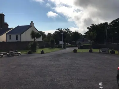 a park with benches and a building and a house at Grammar Lodge Guest House in Campbeltown