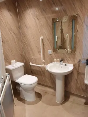 a bathroom with a toilet and a sink at Grammar Lodge Guest House in Campbeltown