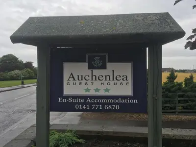 a sign for a guest house on the side of a road at Auchenlea bed and breakfast in Coatbridge
