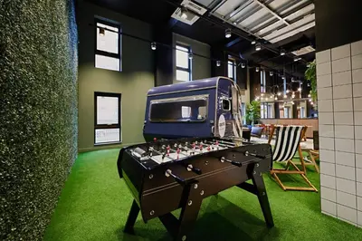 a ping pong table with a bus on top of it at For Students Only Modern studios in Glasgow West End in Glasgow
