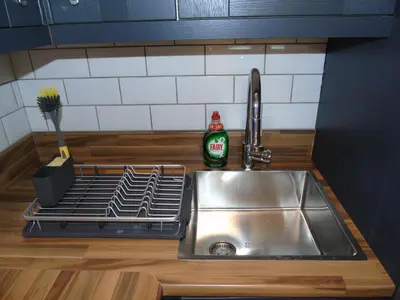 a stainless steel sink in a kitchen next to a sink at Snug - Sealladh Mara Apartment in Helensburgh
