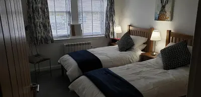 a hotel room with two beds and a window at One The Cairns in Connel