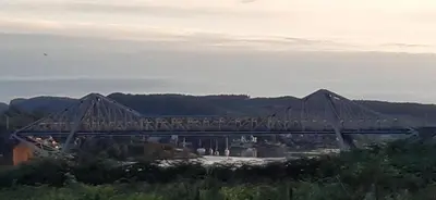a bridge over a river with a train on it at One The Cairns in Connel
