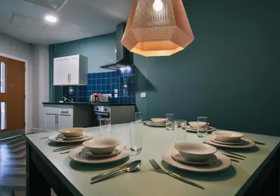 a kitchen with a table with plates and utensils at iQ Grove Accomodation in Edinburgh in Edinburgh