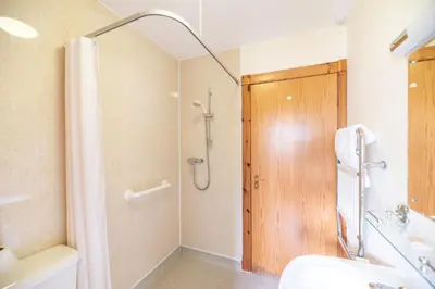 a bathroom with a shower and a sink at Capercaillie Cottage in Crianlarich