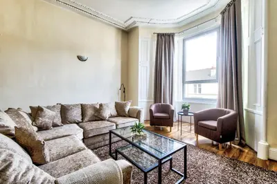 a living room with a couch and a table at Stunning 5 bedroom apt, close to city centre, SEC, Hydro and motorway in Glasgow