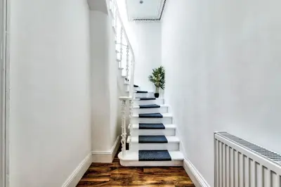 a stairway with blue and white stairs at Stunning 5 bedroom apt, close to city centre, SEC, Hydro and motorway in Glasgow