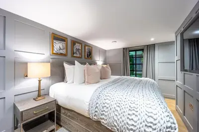 a bedroom with a large bed and a television at No1 Apartments Edinburgh - New Town in Edinburgh