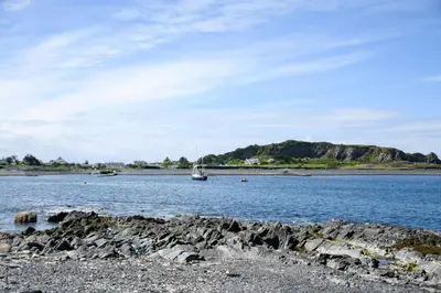 a boat in a large body of water at Easdale Cottage in Oban