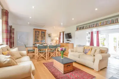 a living room with two couches and a table at Easdale Cottage in Oban