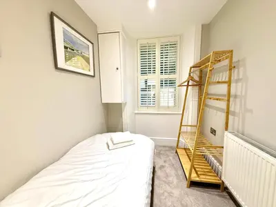 a bedroom with a bed and a ladder in it at Ultra Modern, Stylish Apartment Next To Princes St in Edinburgh