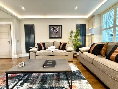 a living room with a couch and a table at Modern 3 Bedroom Apartment, West End in Edinburgh