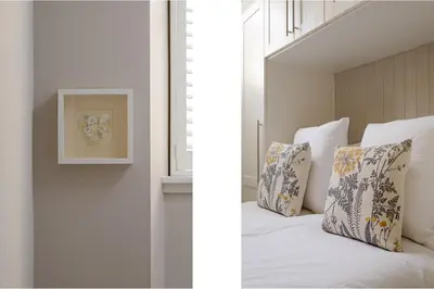 a bedroom with a bed with pillows and a window at The Rose Street Retreat by Calton Living in Edinburgh