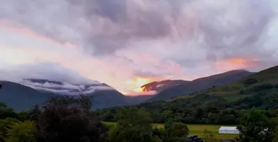 a sunset over a valley with mountains and trees at Glenorchy Lodge Hotel-Rooms Only in Dalmally