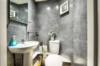 a bathroom with a white toilet and a sink at Lothian Road - perfect city centre location. in Edinburgh