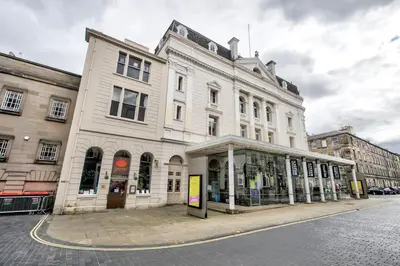 a large white building on the corner of a street at Lothian Road - perfect city centre location. in Edinburgh