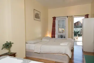 a bedroom with two beds and a window at 7 Bedroom Townhouse in Edinburgh