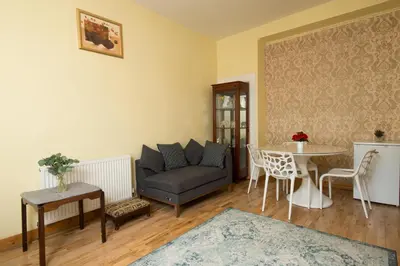 a living room with a couch and a table at 7 Bedroom Townhouse in Edinburgh