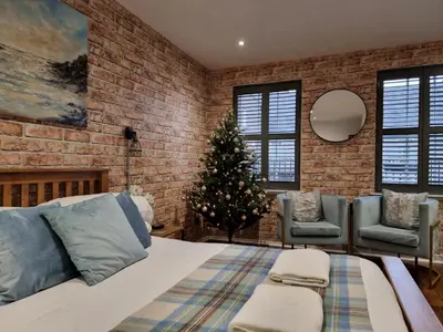 a bedroom with a christmas tree and a bed at Studio Hart Castle Rock Grassmarket in Edinburgh