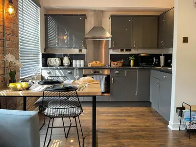 a kitchen with a table and some chairs in it at Studio Hart Castle Rock Grassmarket in Edinburgh