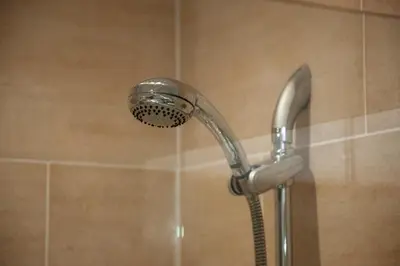 a shower with a shower head in a bathroom at 5 bed house near Oban in Oban