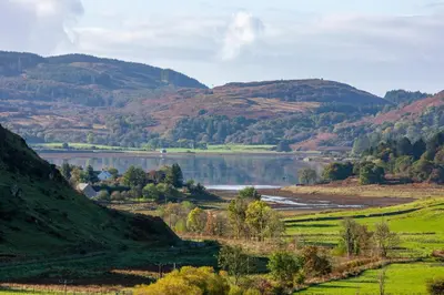 a view of a valley with a lake and mountains at 5 bed house near Oban in Oban
