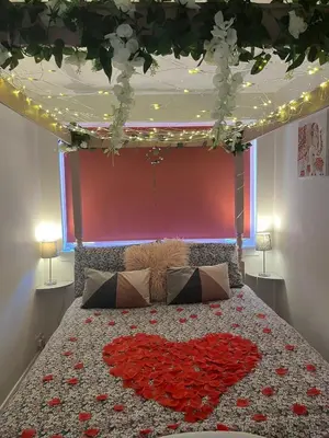 a bed with a heart made out of roses at The Cabin with optional Hot Tub Projector DEPOSIT REQUIRED FOR PROJECTOR in Bonnybridge