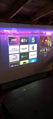 a television screen with a movie on it at The Cabin with optional Hot Tub Projector DEPOSIT REQUIRED FOR PROJECTOR in Bonnybridge