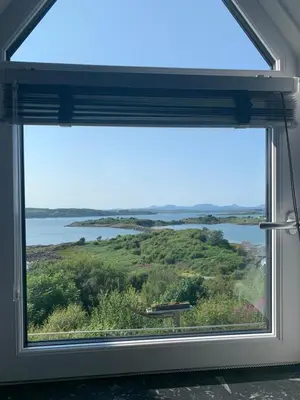 a window with a view of a lake at Corrie House in Craobh Haven