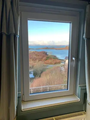 a window with a view of a body of water at Corrie House in Craobh Haven