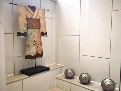 a room with two dresses hanging on a wall at Iona in Stirling