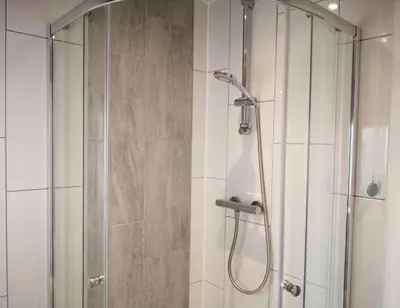 a bathroom with a shower with a glass door at Iona in Stirling