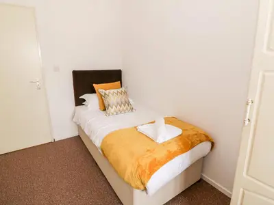 a bedroom with a bed with two pillows on it at Brunston Castle in Girvan
