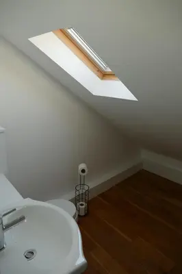 a bathroom with a white sink and a skylight at The Annexe at Loch View Farm in Crieff
