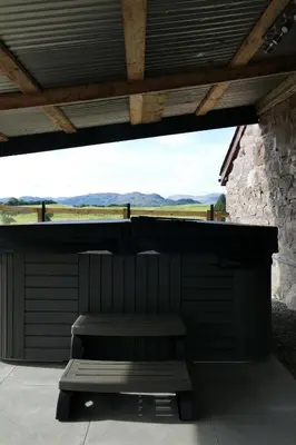 a bench sitting on a porch with a roof at The Annexe at Loch View Farm in Crieff