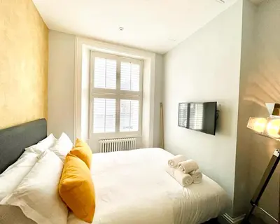 a bedroom with a white bed with towels on it at Gorgeous 2BR & Central Edinburgh Bolt-hole in Edinburgh