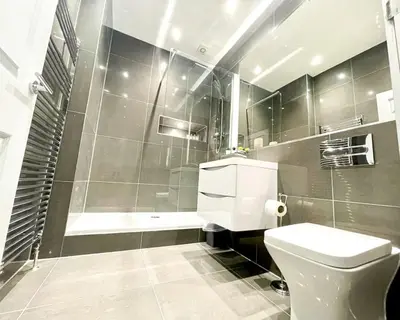 a bathroom with a white toilet and a shower at Gorgeous 2BR & Central Edinburgh Bolt-hole in Edinburgh