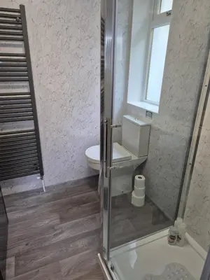 a bathroom with a shower with a toilet and a sink at Firthview House in Kirn