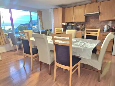 a kitchen and dining room with a table and chairs at Firthview House in Kirn