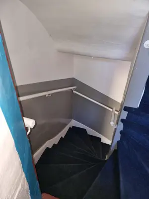 an empty stairs in a room with a stair case at Carrick - One Bed Apartment in Largs