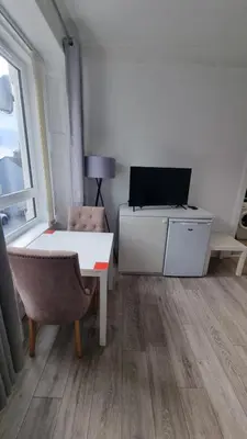 a room with a desk and a tv and a chair at Carrick - One Bed Apartment in Largs